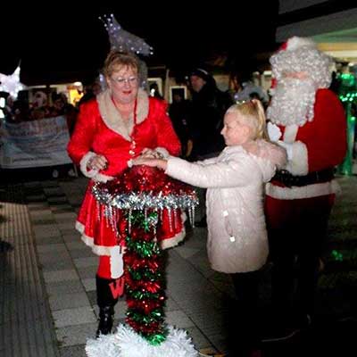 Festive Lights in Fleetwood being switched on by a young girl with Santa and Mrs Claus